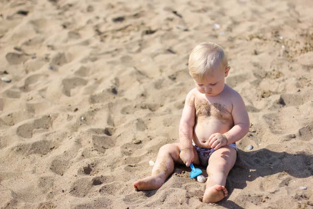 Baby playing on beach