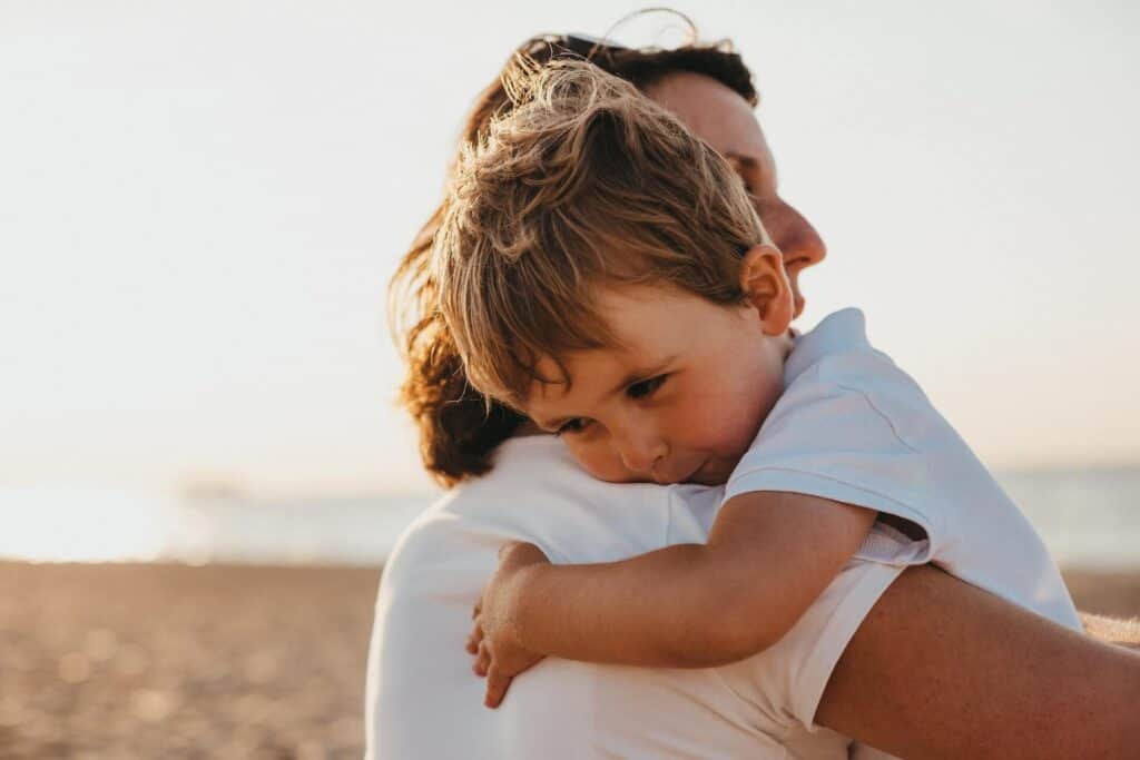 Mom hugging her toddler son tightly