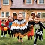 Kids laughing and running during a Halloween party