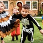 Kids laughing and running during a Halloween party