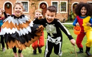 Kids laughing and running during a Halloween party