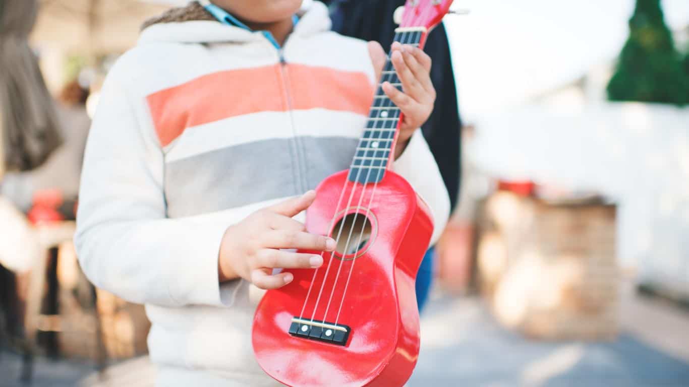 kid playing ukulele