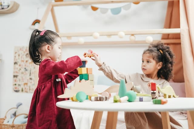 Preschool kids playing blocks together at school