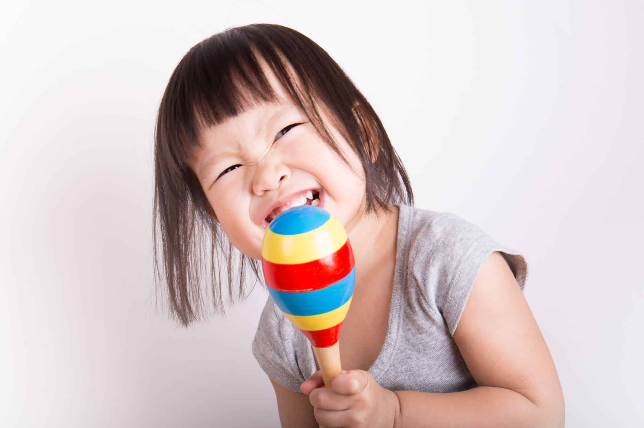 Toddler girl playing instrument in music class