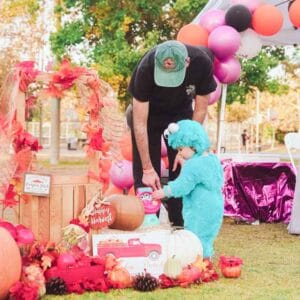 A man in a costume and a child at a Halloween party, having a boo-tastic time.