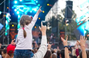 Child enjoying live music concert with parent at Los Angeles venue