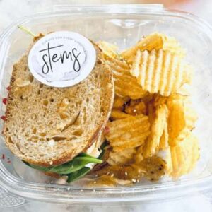 a sandwich and chips in a plastic container