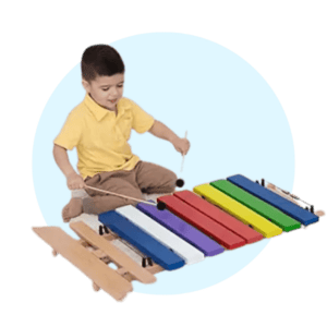 boy playing giant xylophone