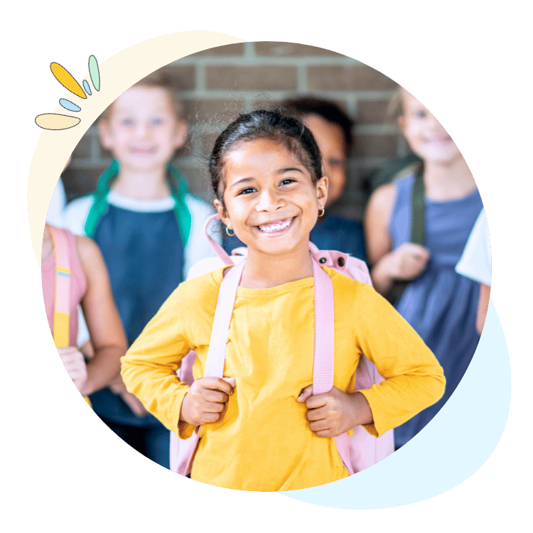 Elementary student wearing a backpack in front of her peers