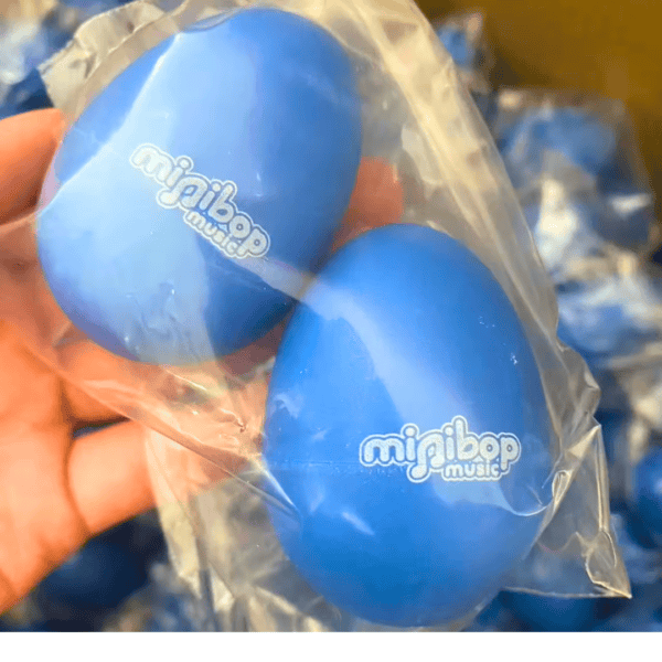 2 egg Minibop shakers being held in a bag by a hand