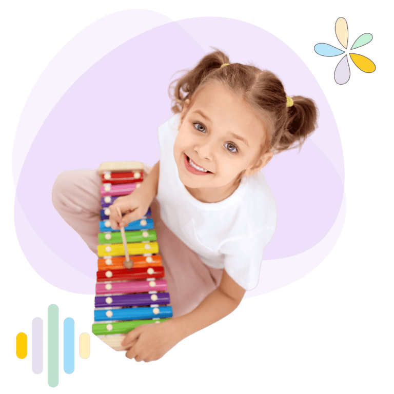 little girl sitting down playing the xylophone